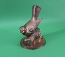 Brass Bird on Log